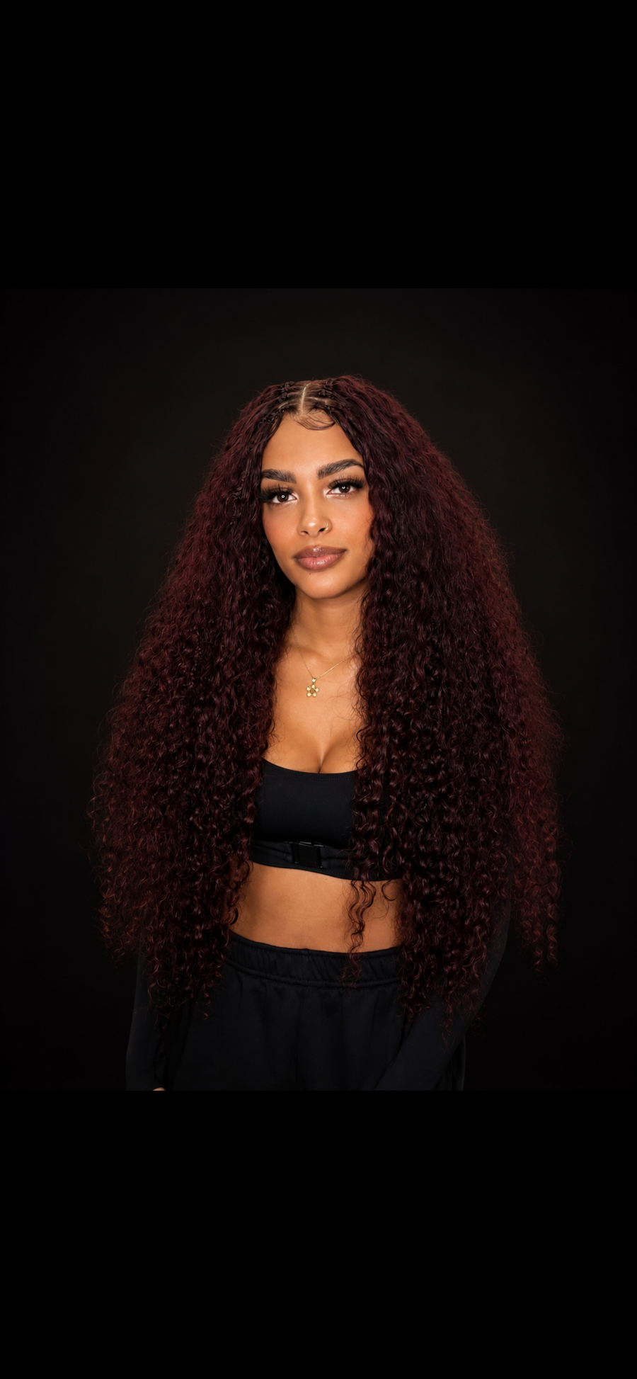 Model wearing Burmese Bundle, front view, burgundy curls past the shoulders